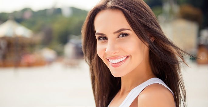 woman smiling after treating wrinkles