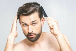 man combing his hair 