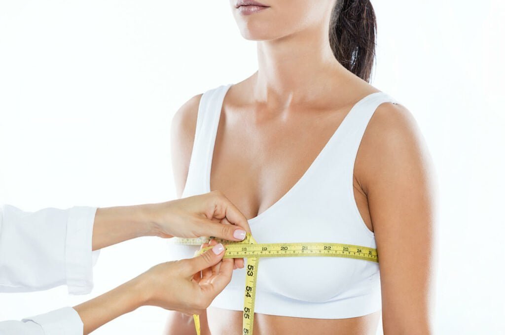 woman having her breasts measured