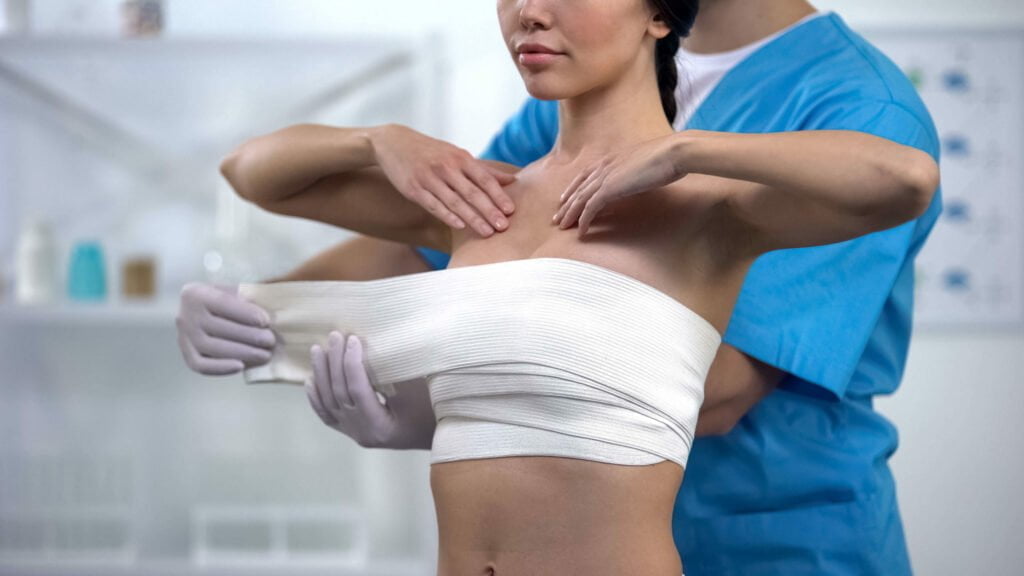 woman with medical bandages on her chest
