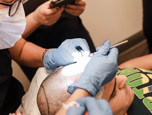 man having scalp prepared for hair transplant