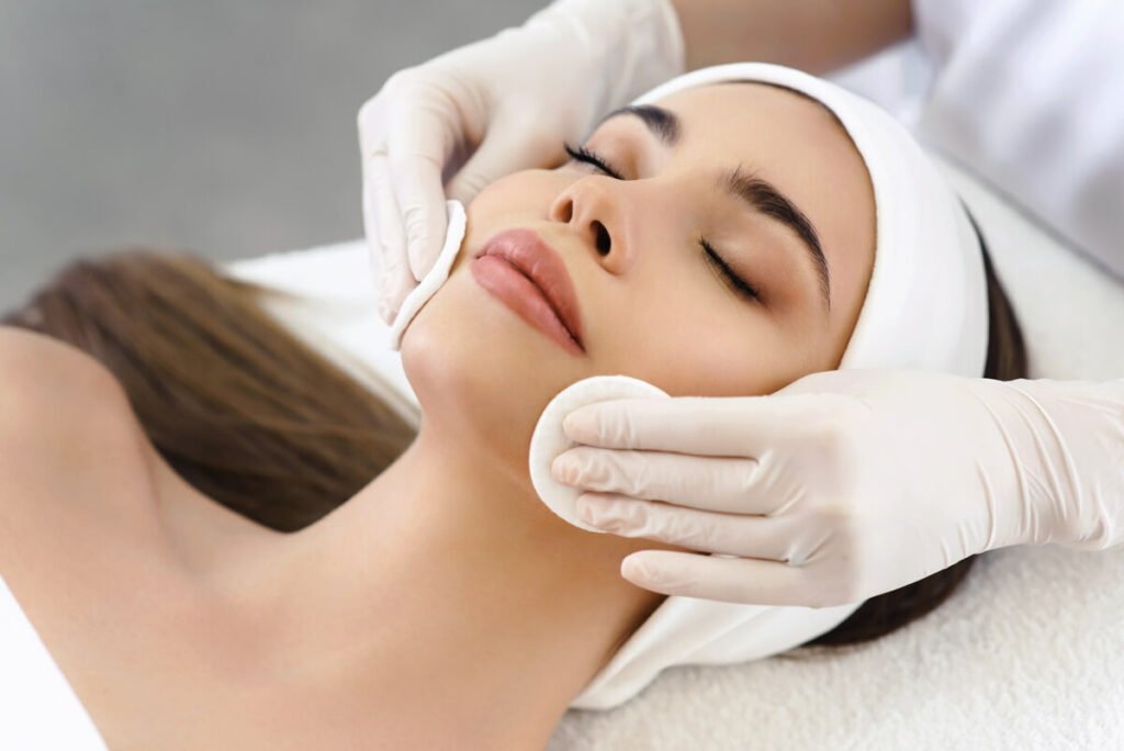 Woman with closed eyes receiving a facial treatment