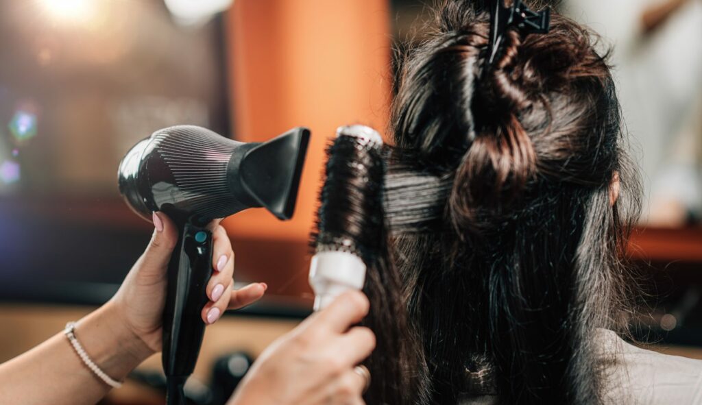 Woman sitting for hair styling