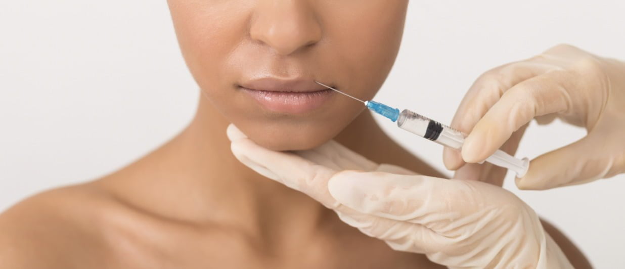 a woman receiving lip injections