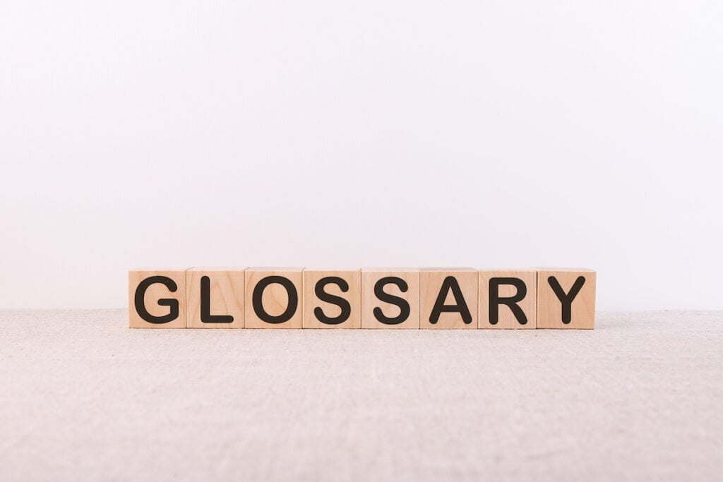 The word “glossary” spelled out with wooden blocks