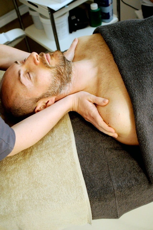 A man reducing stress lying on a massage table