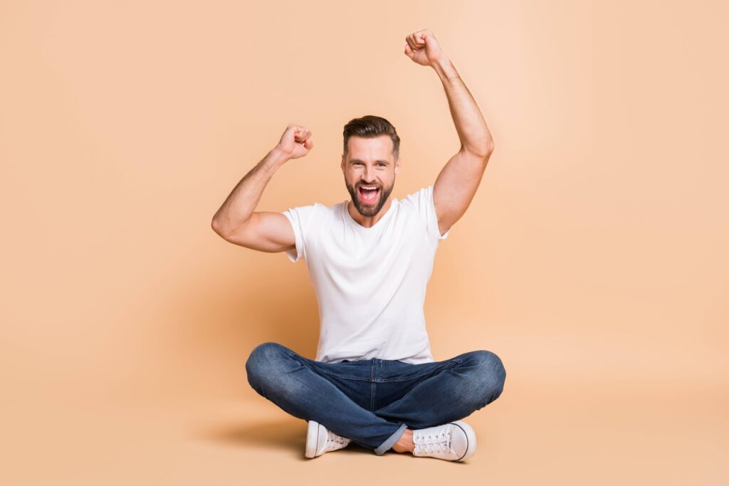 A sitting man who has seen incredible hair transplant results