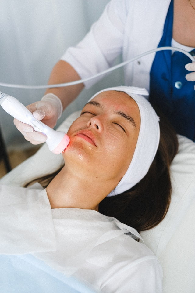 A doctor doing a face anti-aging procedure for patient