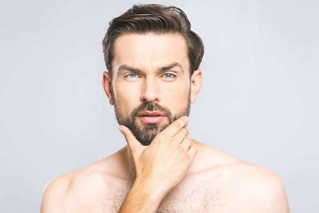 Sitting man very pleased with his noninvasive hair restoration