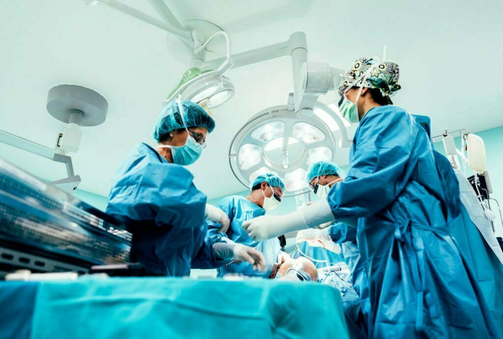 Doctors and nurses in the operating room performing liposuction surgery