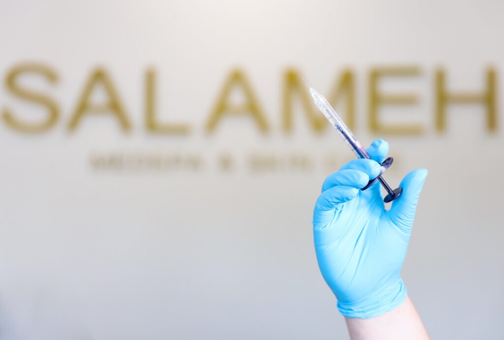 A desk staff at Salameh Plastic Surgery Center taking calls for a consultation