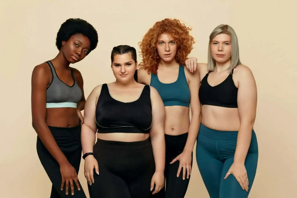 Two plus-size female friends in sportswear are standing together